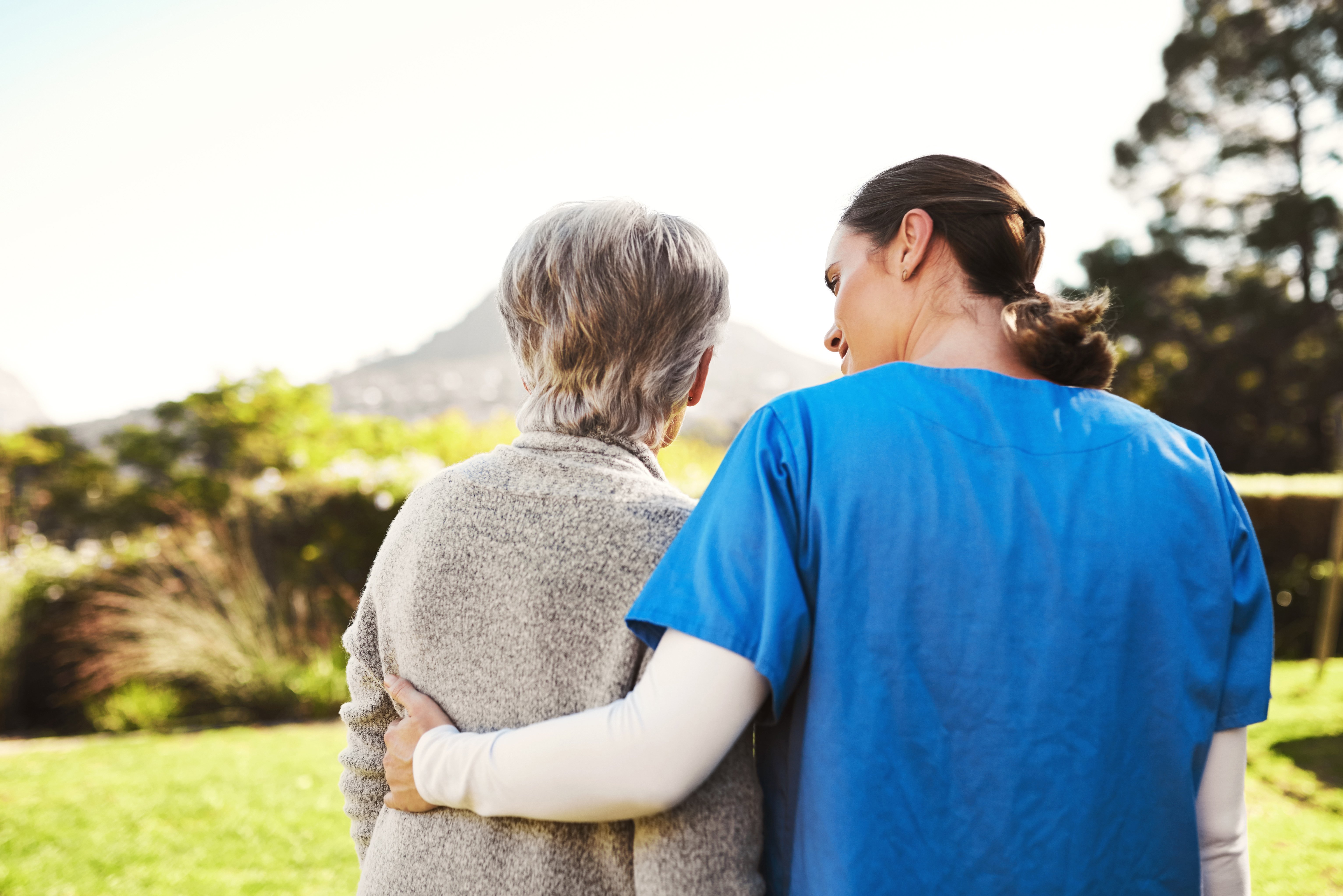 Cropped shot of a young female nurse outside with a senior patient
